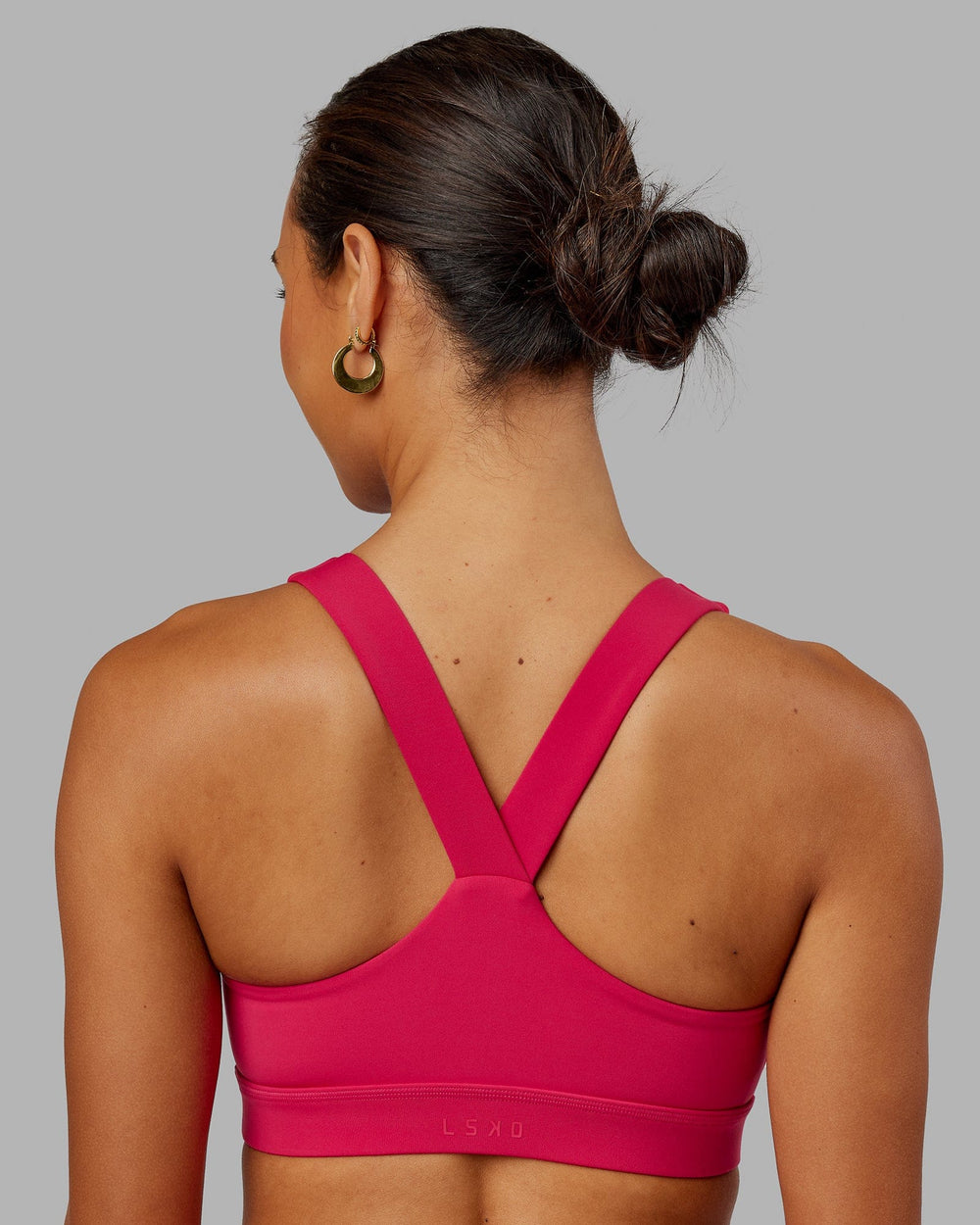 Woman wearing Rep Sports Bra Small Logo - Boysenberry