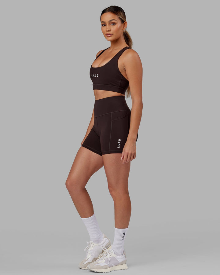 Woman wearing Rep Sports Bra Small Logo - Dark Walnut