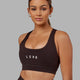 Woman wearing Rep Sports Bra Small Logo - Dark Walnut