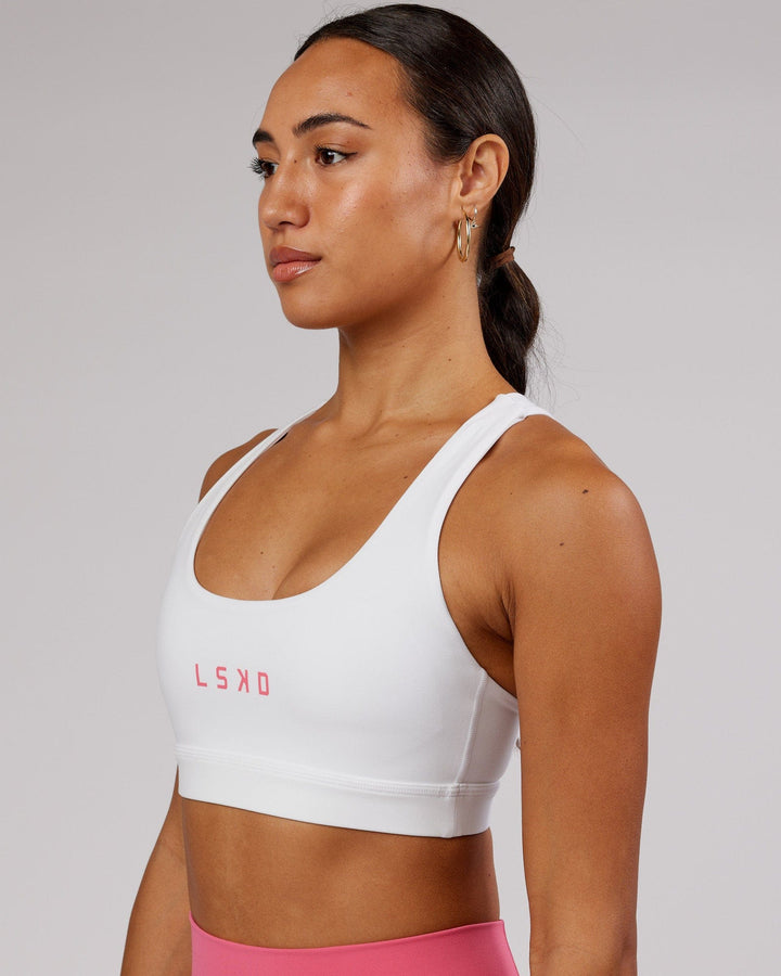 Woman wearing Rep Sports Bra Small Logo - White-Flamingo