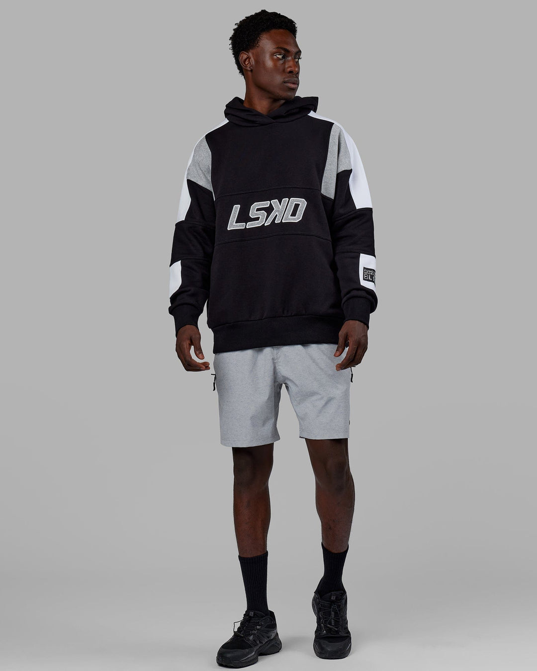 Man wearing Unisex Slam Hoodie Oversize - Black-Lt Grey Marl