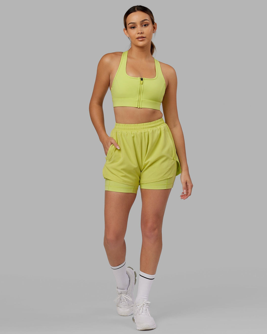 Woman wearing. Sprint Bra - Citrus Green