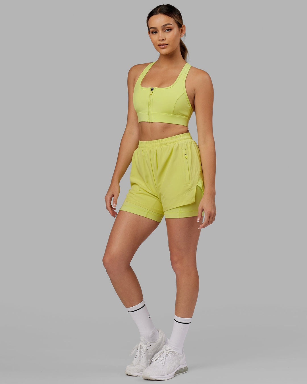 Woman wearing. Sprint Bra - Citrus Green