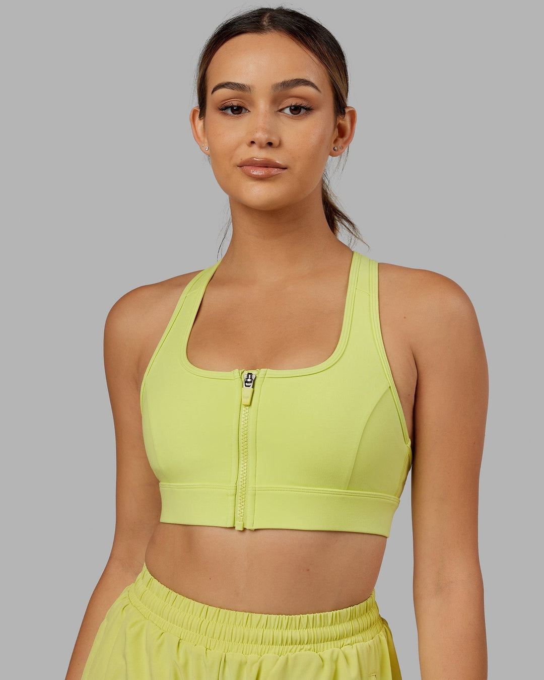 Woman wearing. Sprint Bra - Citrus Green