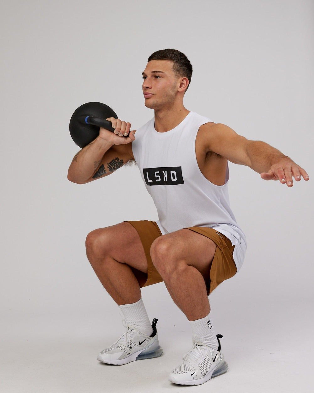 Man wearing Strength FLXCotton Training Fit Tank - White-Black