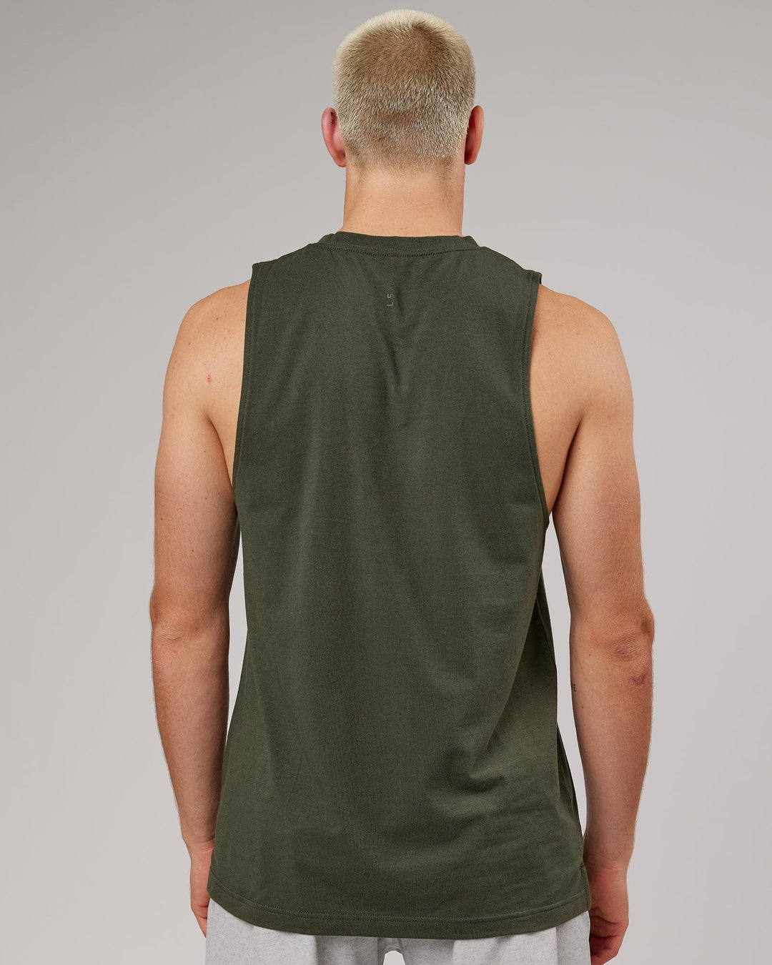Man wearing Strength FLXDRY Performance Tank - Forest Night