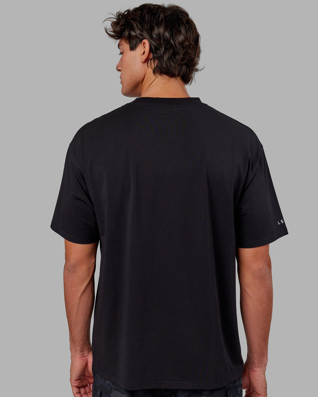 Man wearing Unisex Strive FLXCotton Tee Oversize - Black-White