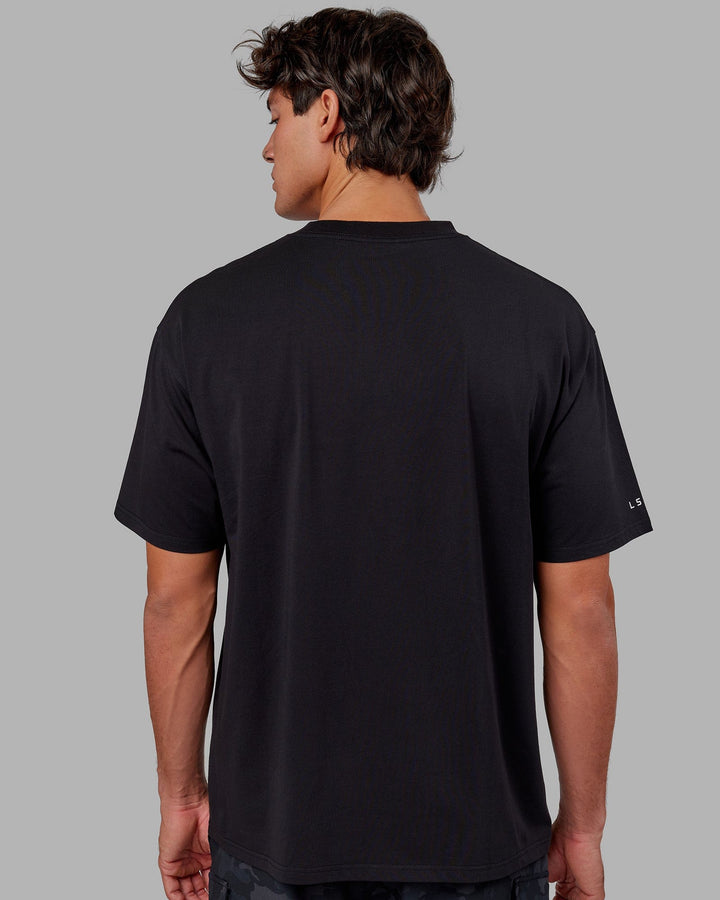Man wearing Unisex Strive FLXCotton Tee Oversize - Black-White