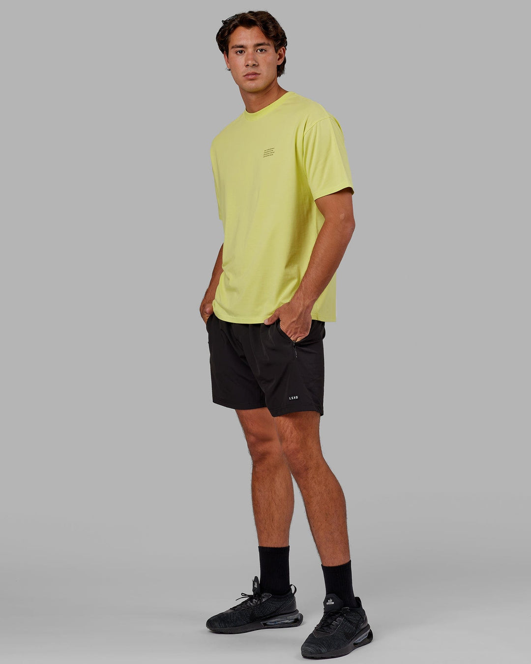 Man wearing Unisex Strive FLXCotton Tee Oversize - Citrus Green