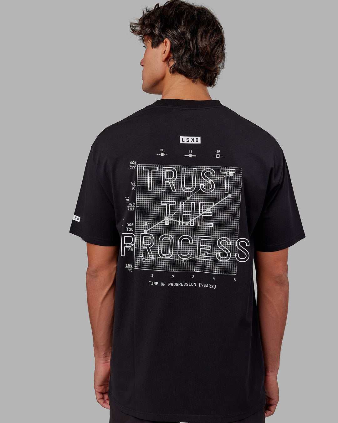 Man wearing Trust The Process FLXCotton Tee Longline Oversize - Black