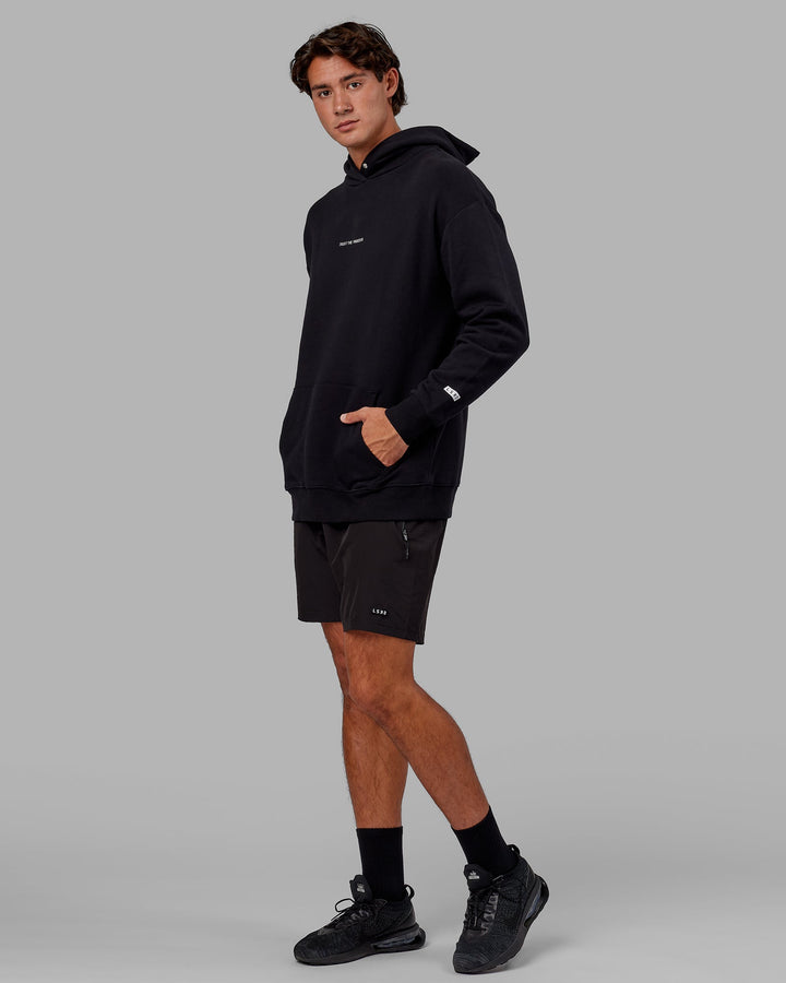 Man wearing Unisex Trust The Process Hoodie Oversize - Black
