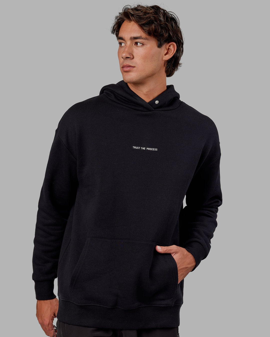Man wearing Unisex Trust The Process Hoodie Oversize - Black