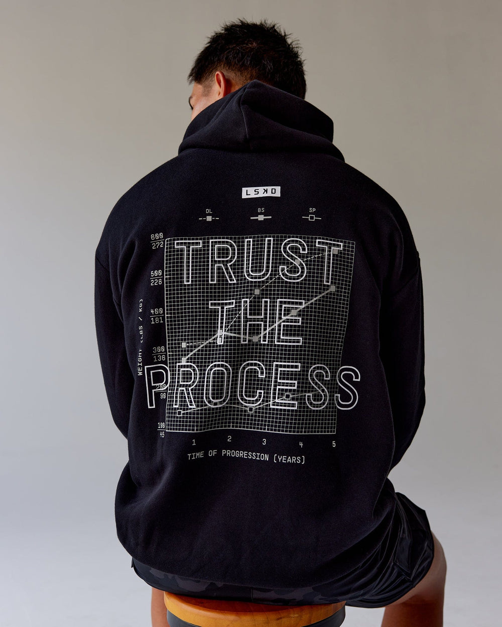 Man wearing Unisex Trust The Process Hoodie Oversize - Black