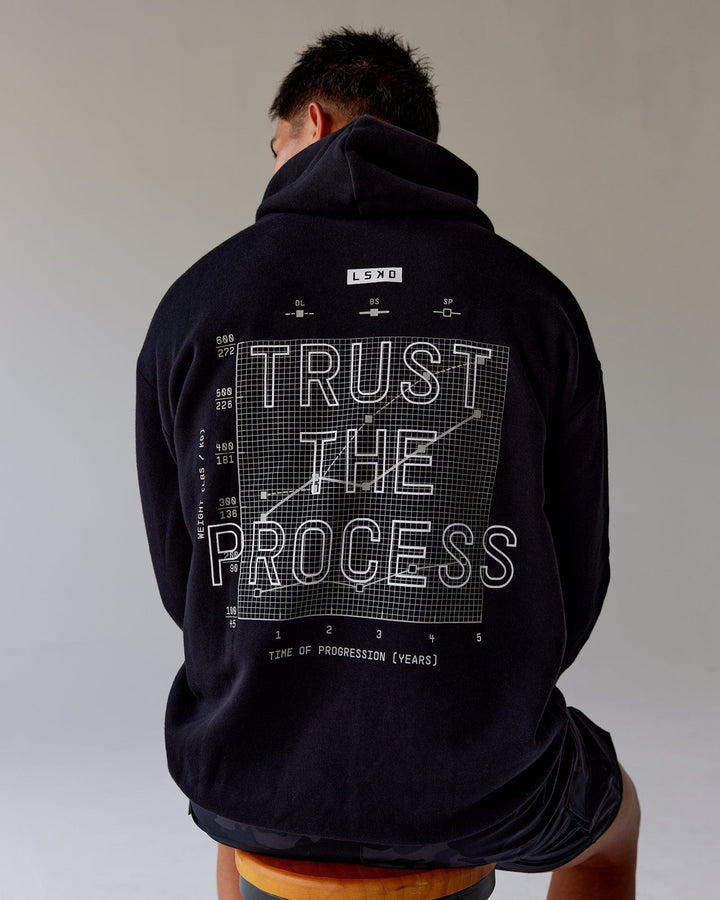 Man wearing Unisex Trust The Process Hoodie Oversize - Black