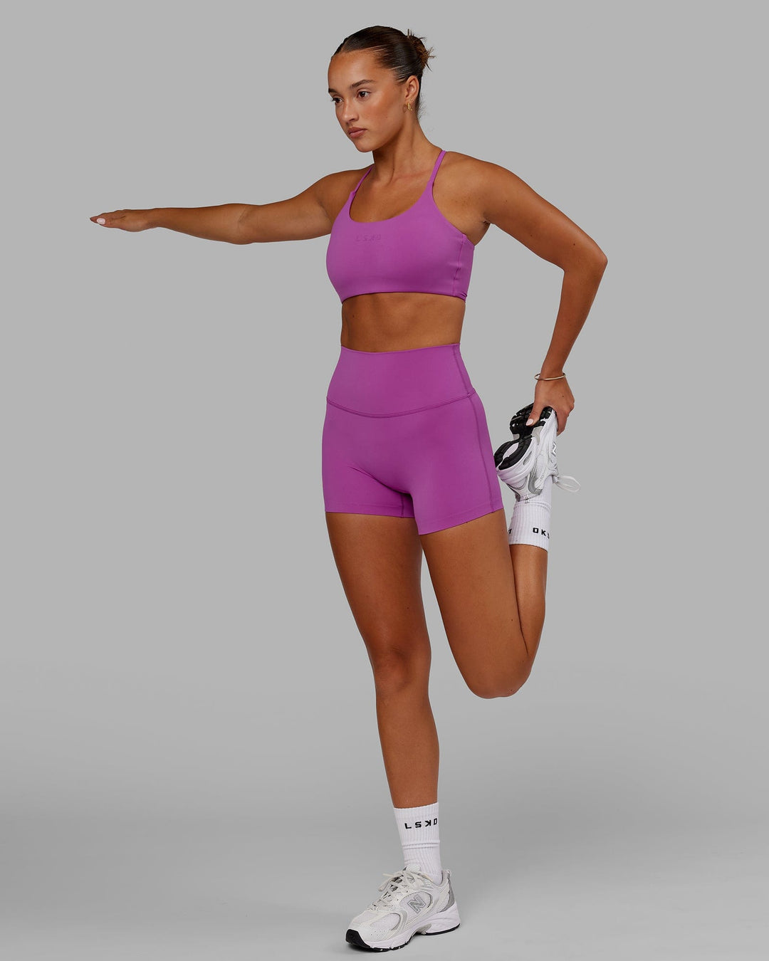 Woman wearing Twist Sports Bra - Orchid