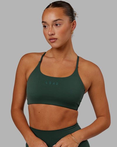 Woman wearing Twist Sports Bra - Vital Green