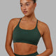 Woman wearing Twist Sports Bra - Vital Green