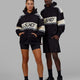 Man and Woman wearing Unisex A-Team Hoodie Oversize - Black-Bone