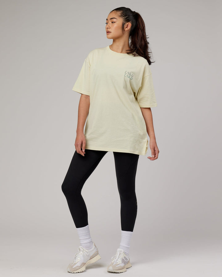 Woman wearingnUnisex Aurora Oversize Tee - Almond Milk