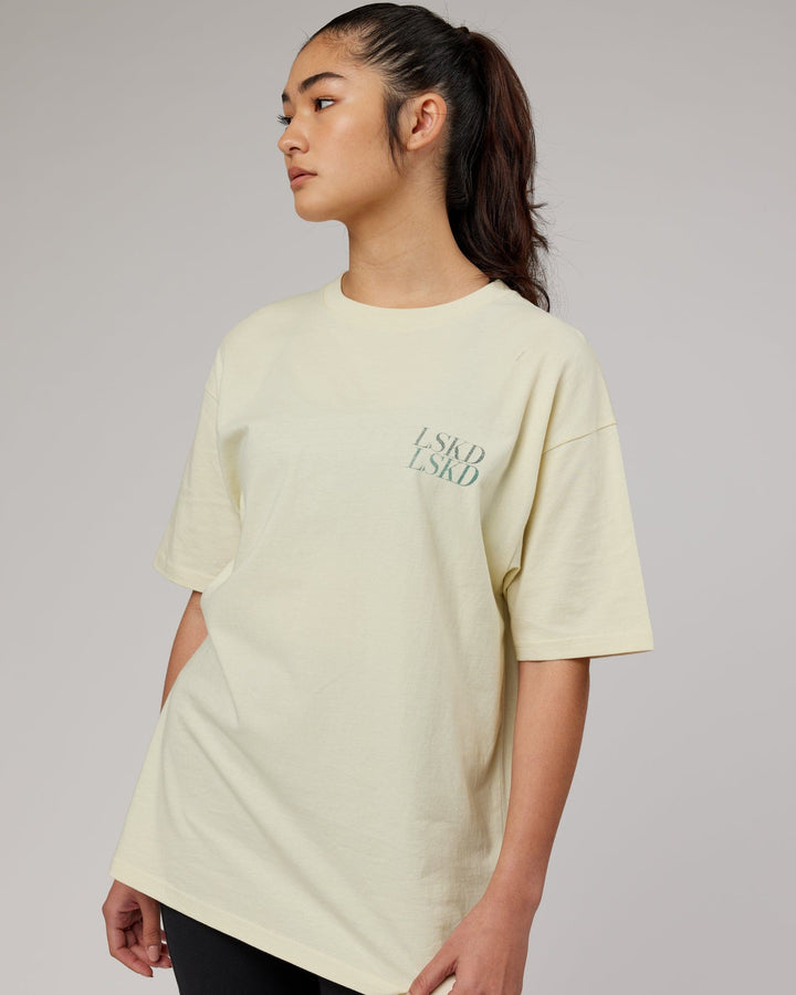 Woman wearingnUnisex Aurora Oversize Tee - Almond Milk