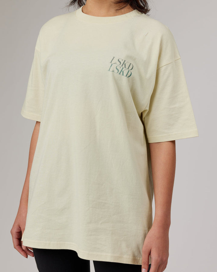 Woman wearingnUnisex Aurora Oversize Tee - Almond Milk
