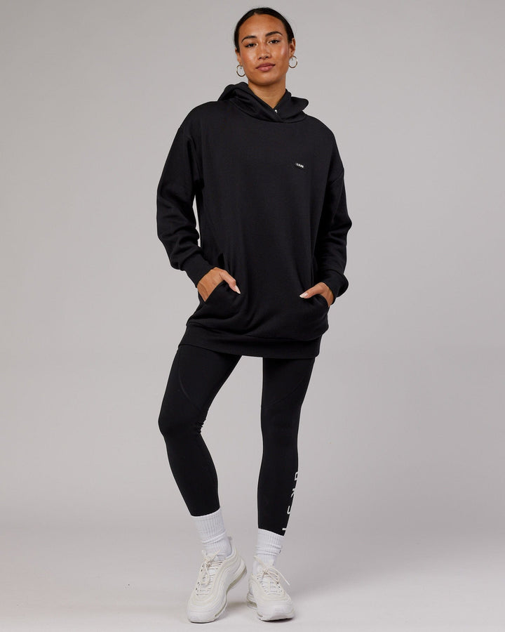 Woman wearing Unisex Capsule Hoodie Oversize - Black