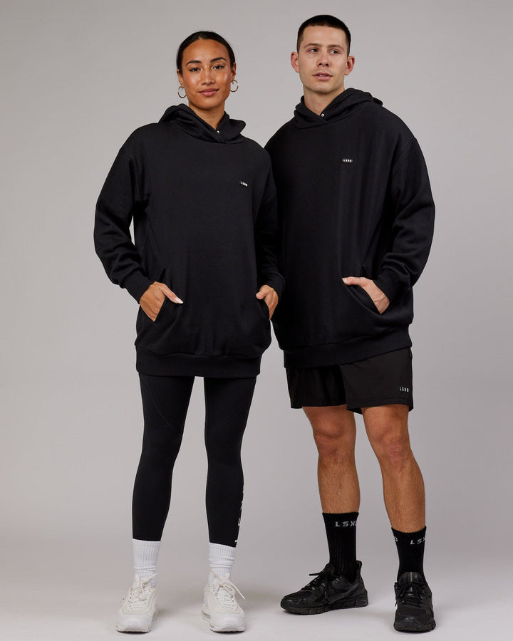 Woman wearing Unisex Capsule Hoodie Oversize - Black
