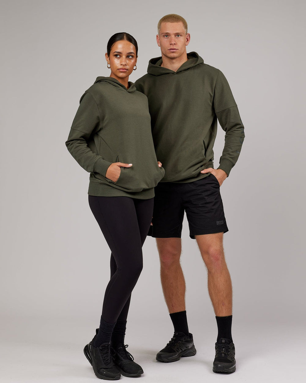 Man and woman wearing Unisex Direction FLXFleece Hoodie - Forest Night