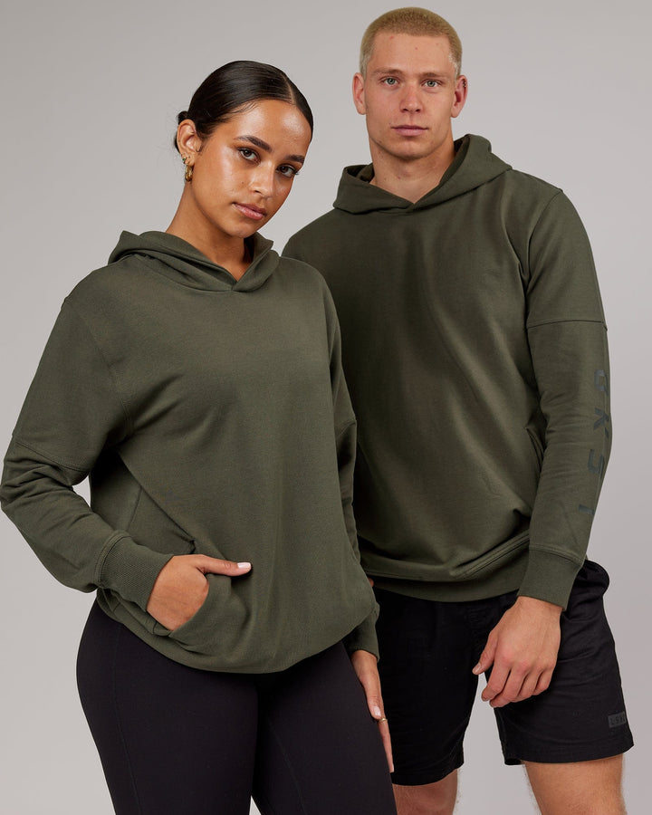 Man and woman wearing Unisex Direction FLXFleece Hoodie - Forest Night