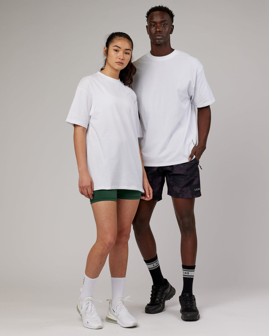 Woman and man wearing Unisex DownLow FLXCotton Oversize Tee - White