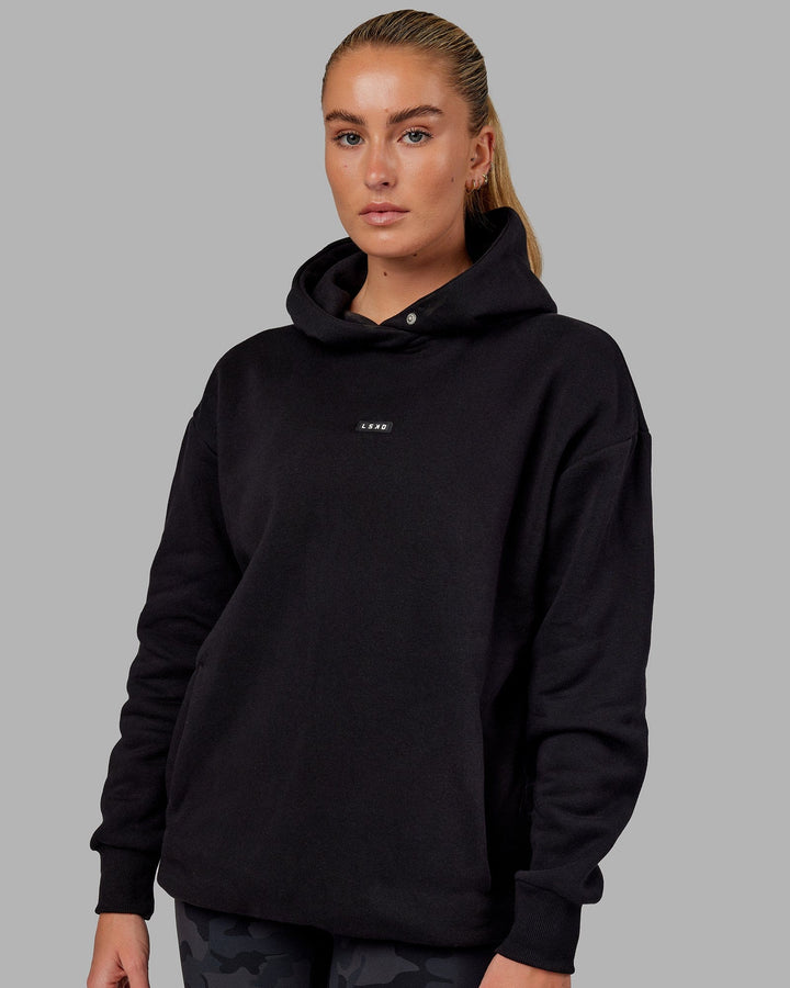 Woman wearing Unisex Fundamental Hoodie Oversize - Black