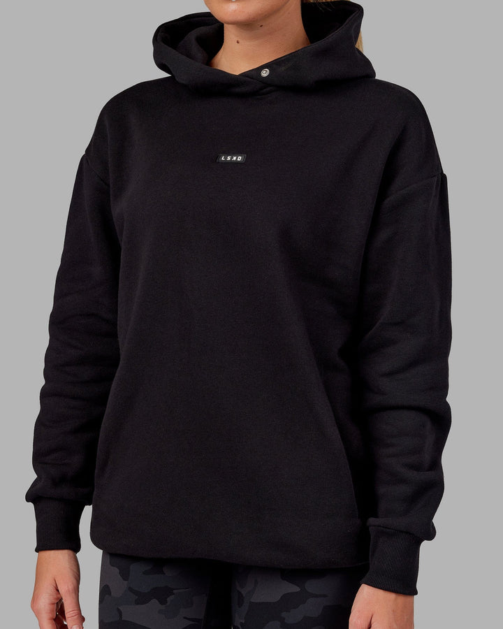 Woman wearing Unisex Fundamental Hoodie Oversize - Black