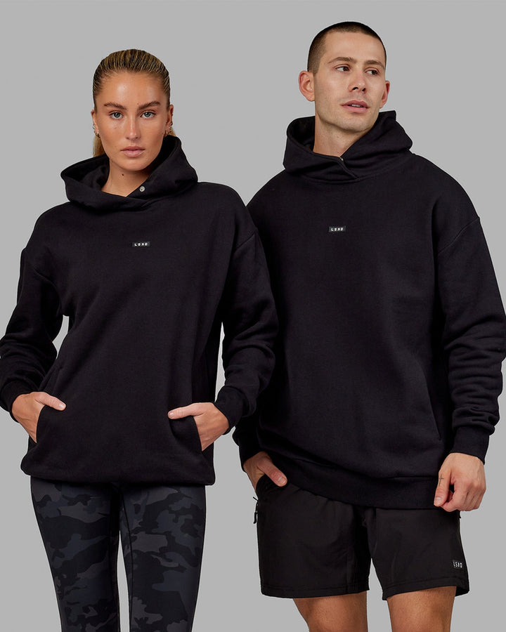 Woman wearing Unisex Fundamental Hoodie Oversize - Black