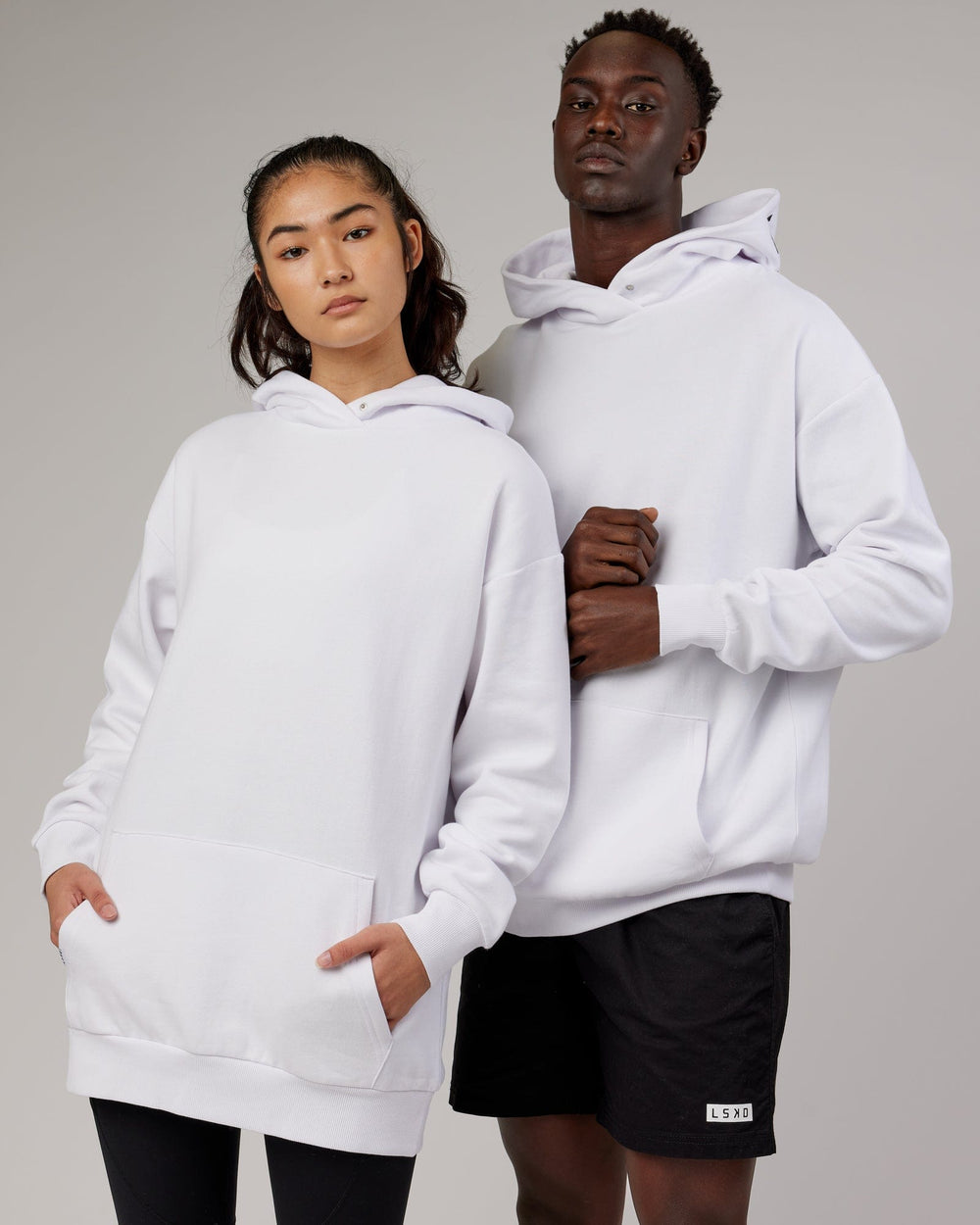 Woman and man wearing Unisex Linear Hoodie Oversize - White