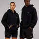 Man and woman wearing Unisex Mode Hoodie Oversize - Black