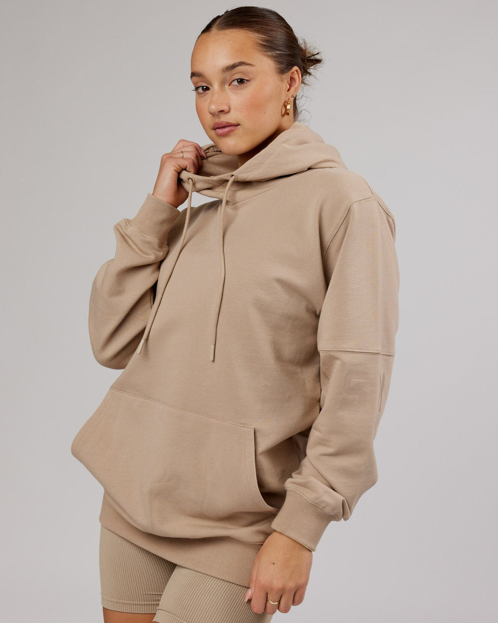 Woman wearing Unisex Perimeter FLXFleece Hoodie - Taupe