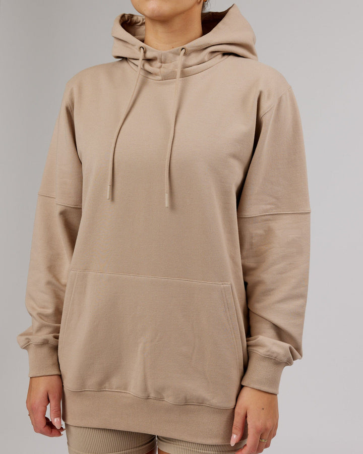 Woman wearing Unisex Perimeter FLXFleece Hoodie - Taupe