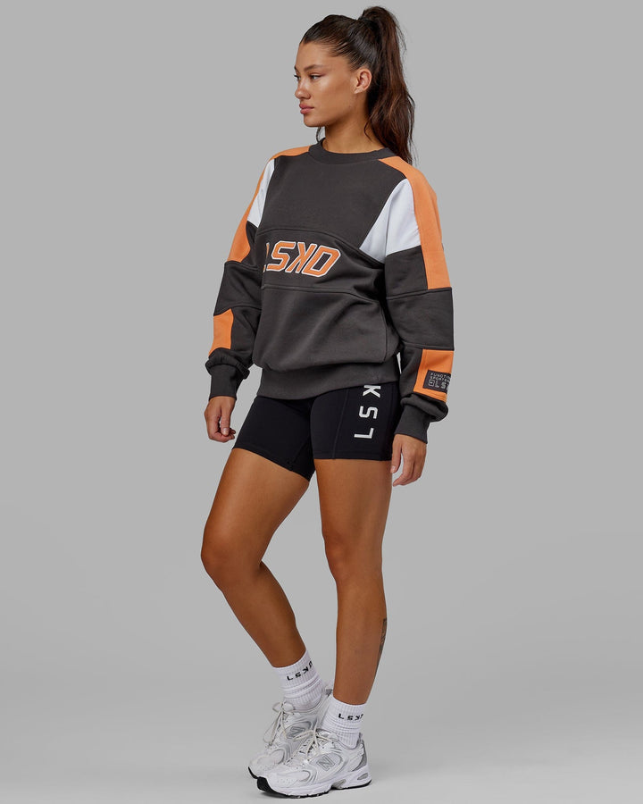 Woman wearing Unisex Slam Sweater Oversize - Asphalt-Tangerine