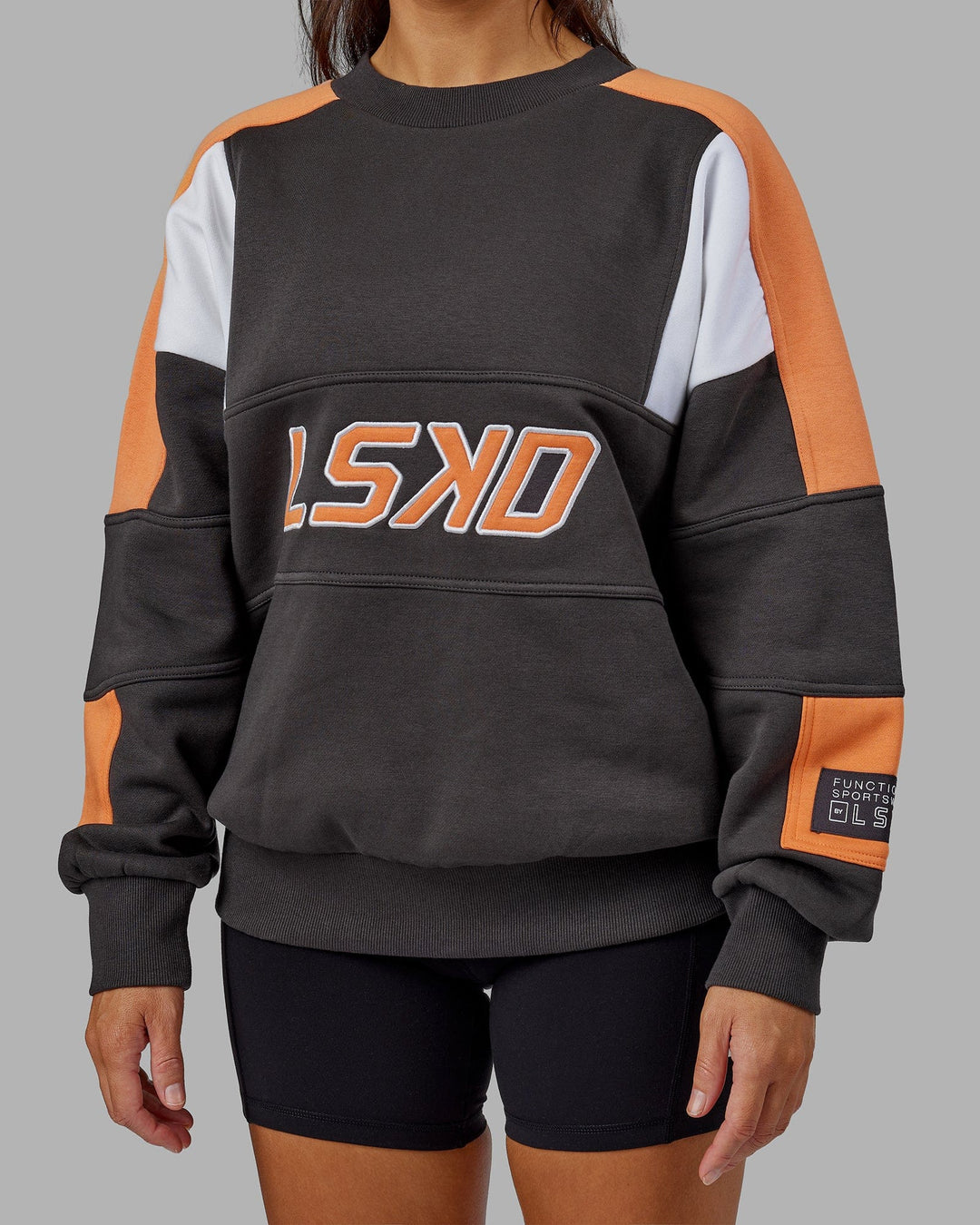 Woman wearing Unisex Slam Sweater Oversize - Asphalt-Tangerine