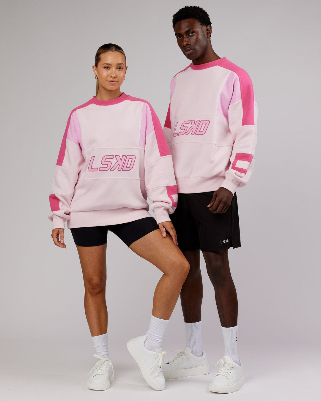 Man and woman wearing Unisex Slam Sweater Oversize - Pink Multi