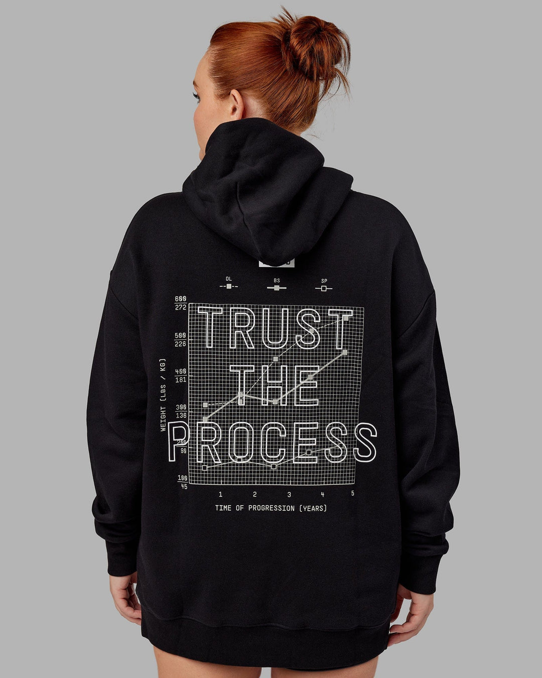 Woman wwearing Unisex Trust The Process Hoodie Oversize - Black