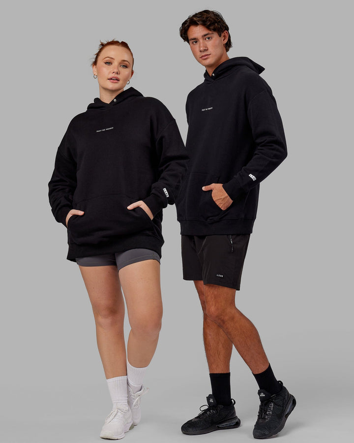 Duo wearing Unisex Trust The Process Hoodie Oversize - Black