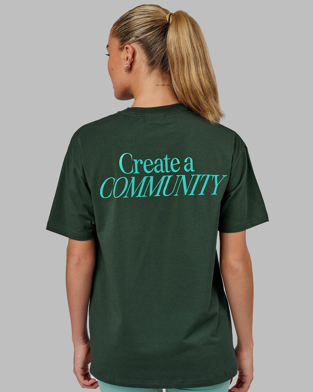 Woman wearing Unisex VS2 FLXCotton Tee Oversize - Vital Green-Teal