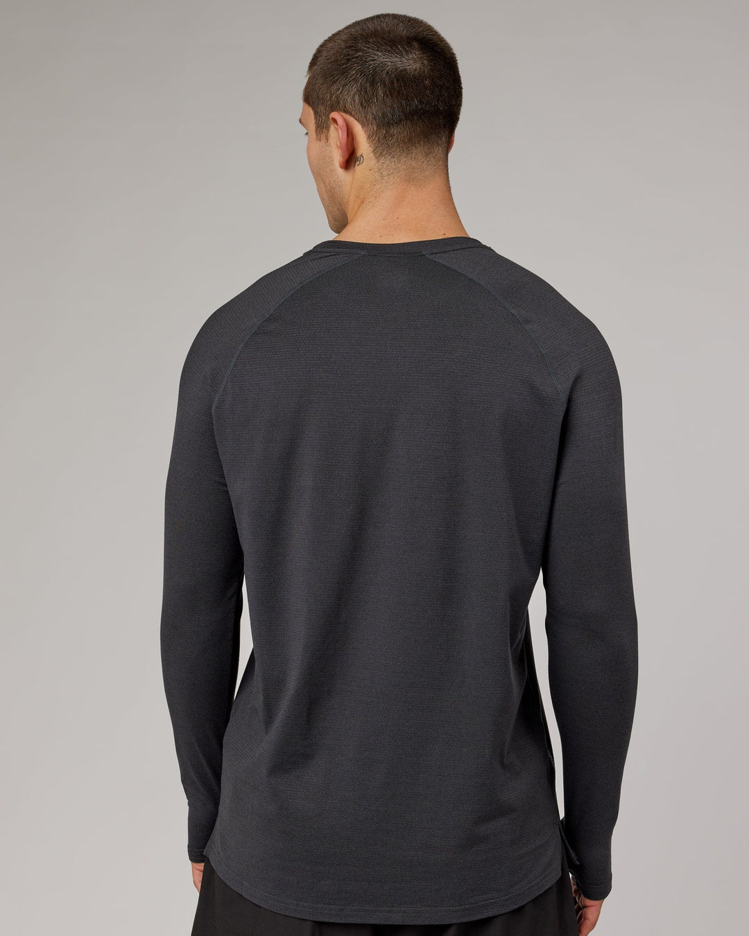 Man wearing Black Marl Perform VapourLFX Long Sleeve Tee