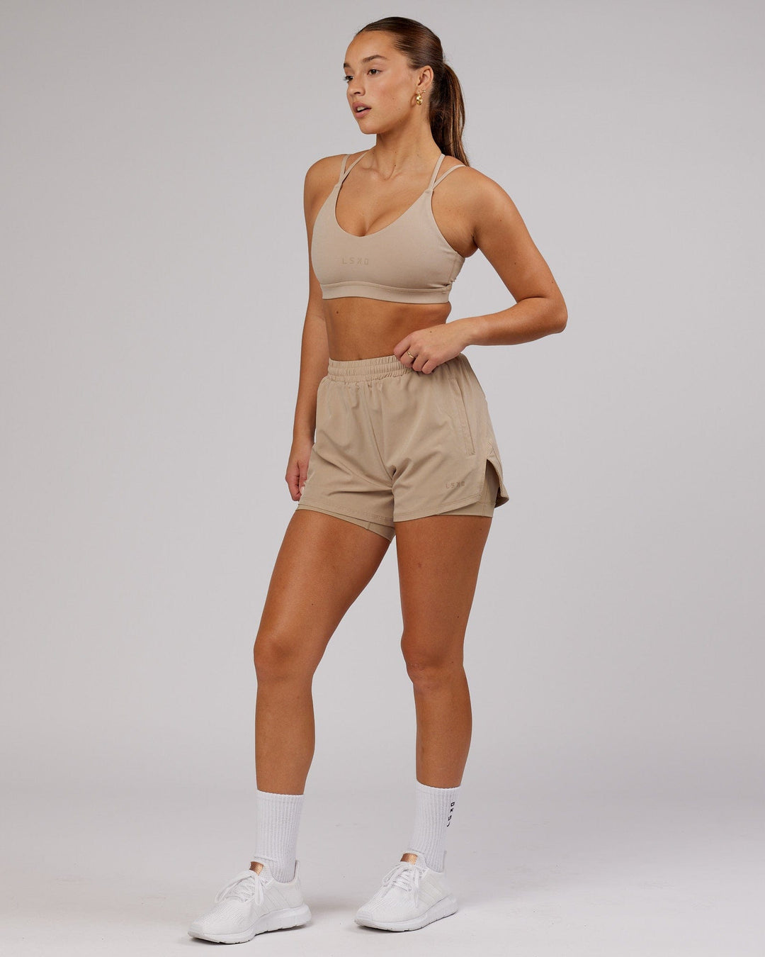 Woman wearing Challenger Run Short - Taupe