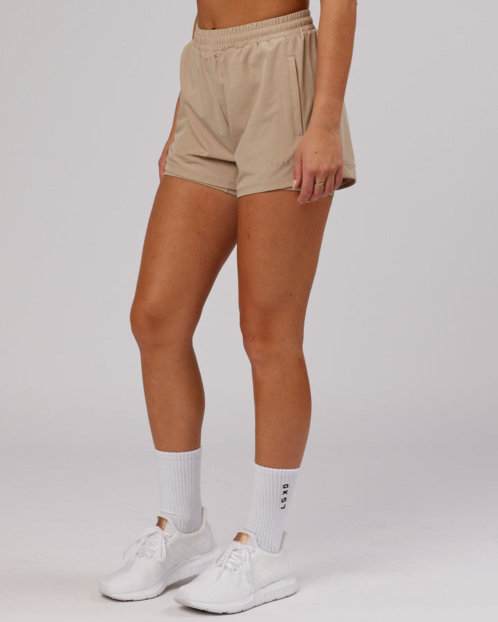 Woman wearing Challenger Run Short - Taupe
