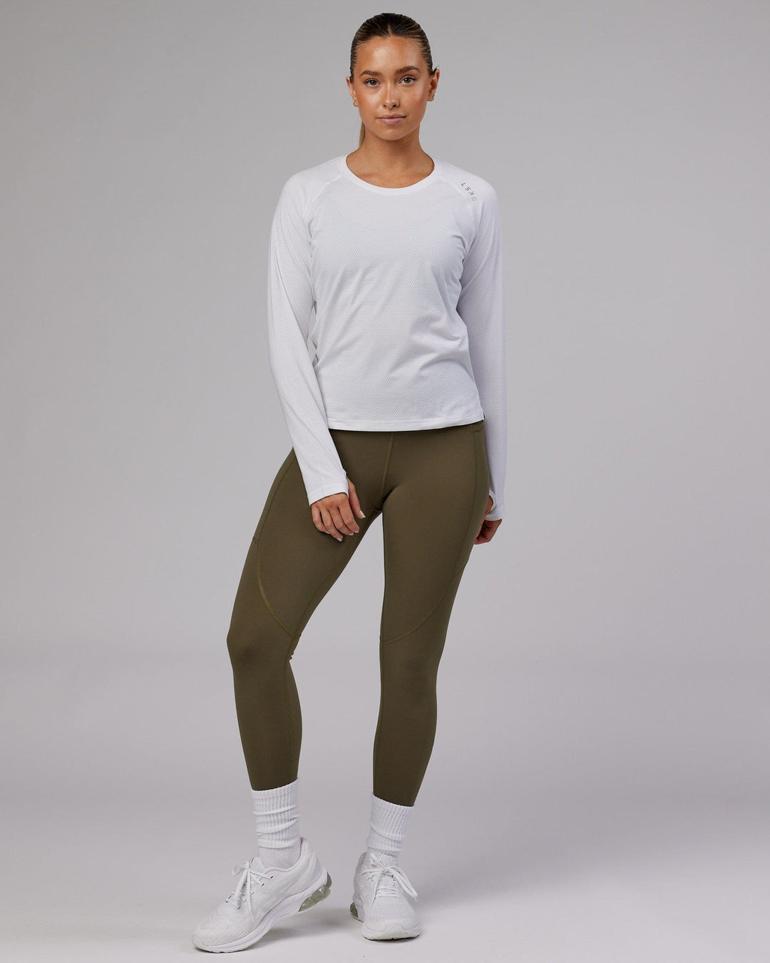 Woman wearing Perform VapourFLX LS Tee - White Marl