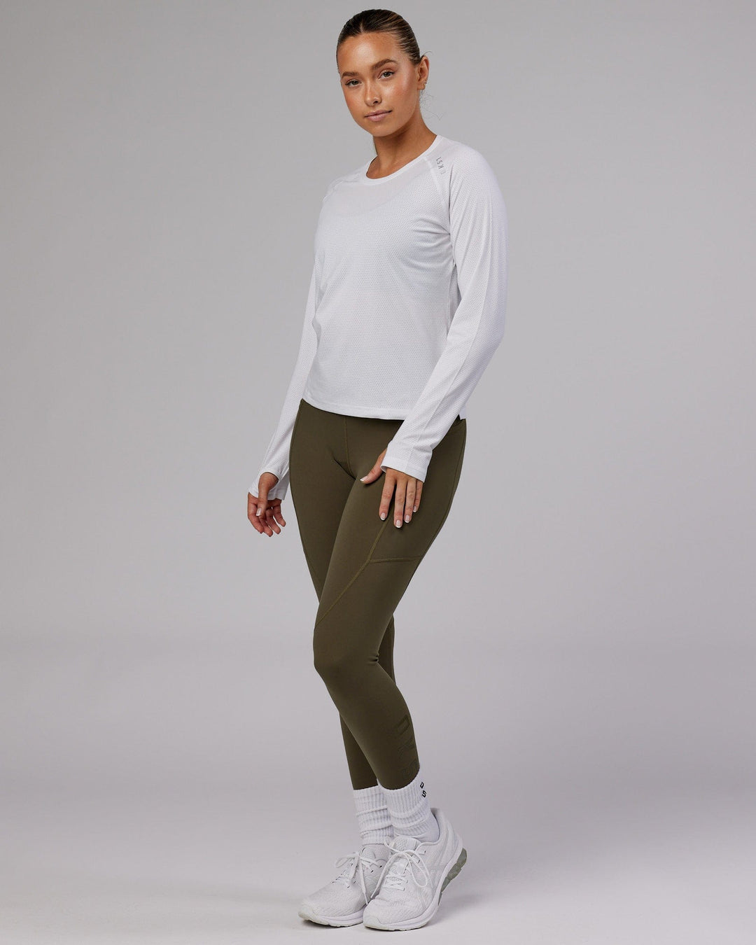 Woman wearing Perform VapourFLX LS Tee - White Marl