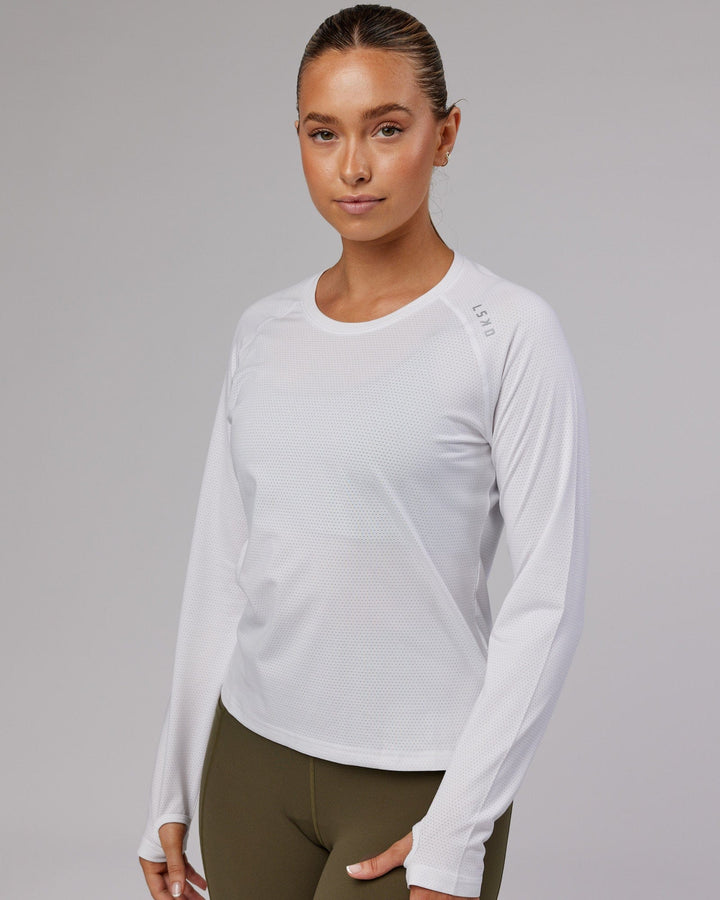 Woman wearing Perform VapourFLX LS Tee - White Marl