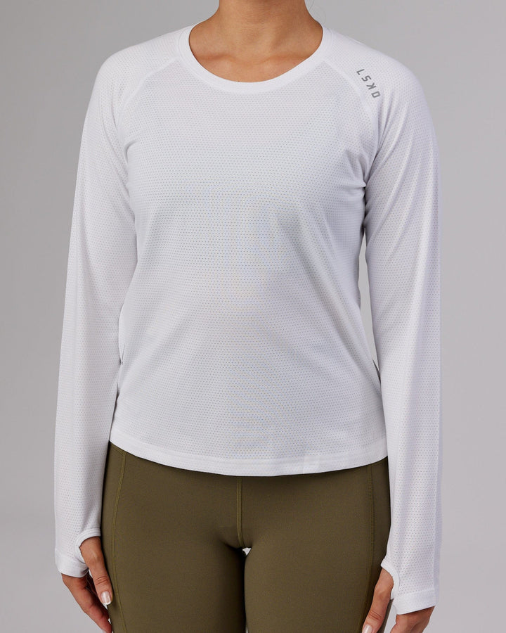 Woman wearing Perform VapourFLX LS Tee - White Marl